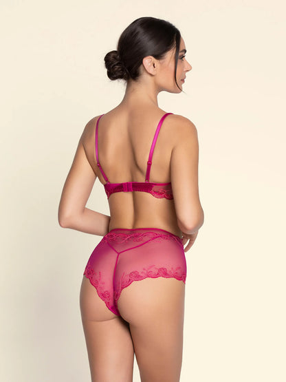 Woman wearing a pink lingerie set on a beige background