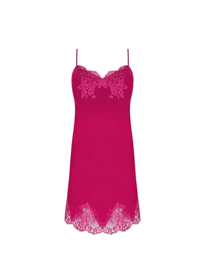 Pink slip dress with lace details on a white background